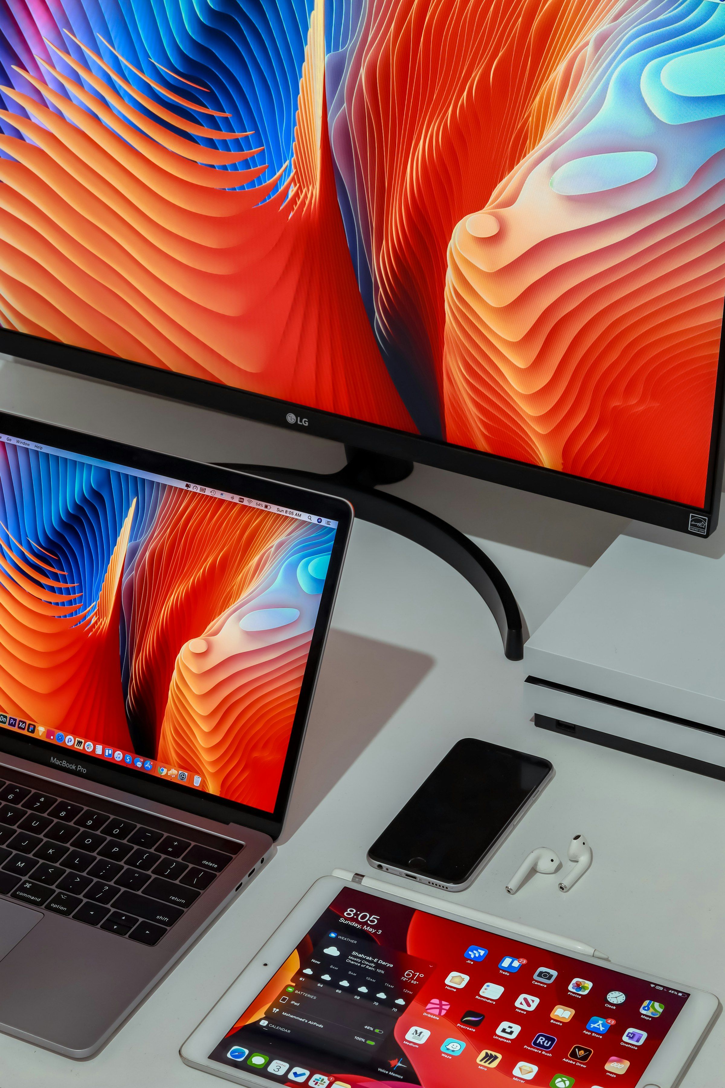 MacBook, iPad, iPhone and AirPods on a desk